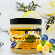 Jar of Blueberry Lemon Cupcake sugar and sea salt scrub with lemons and blueberries on a white background